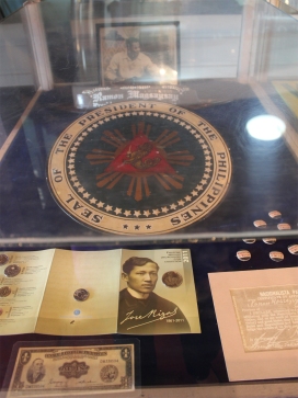 Seal of the Philippine President; Photo of Jose Rizal in the foreground